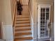 Bright stairway with white beadboard wainscoting and wood stairs leading to the upper level at 107 Heatherwood Trce, Acworth, GA 30101