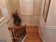 Traditional staircase with wooden steps and decorative wainscoting, bathed in natural light from the window at 107 Heatherwood Trce, Acworth, GA 30101