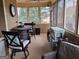 Inviting sunroom with a round table, comfortable seating, and large windows offering scenic views and natural light at 107 Heatherwood Trce, Acworth, GA 30101