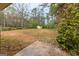 Large, partially wooded backyard featuring a storage shed and mature trees, perfect for outdoor activities at 203 Greensprings Dr, Palmetto, GA 30268