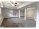 Spacious finished basement with neutral carpeting, ceiling fans, and support columns at 203 Greensprings Dr, Palmetto, GA 30268