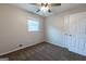 Neutral bedroom with ceiling fan, a window for natural light, and a closet for storage at 203 Greensprings Dr, Palmetto, GA 30268