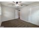 Spacious bedroom with ceiling fan, cozy carpet, closet, and natural light from the window at 203 Greensprings Dr, Palmetto, GA 30268