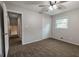 Comfortable carpeted bedroom with a ceiling fan, window, and easy access to the hallway at 203 Greensprings Dr, Palmetto, GA 30268