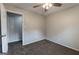 Simple bedroom features soft carpeting, a ceiling fan, and doorway views at 203 Greensprings Dr, Palmetto, GA 30268