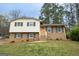 Charming split-level home featuring a bright, welcoming door and manicured lawn at 203 Greensprings Dr, Palmetto, GA 30268