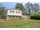 Charming two-story home with brick and vinyl siding, inviting front yard, and traditional architectural details at 203 Greensprings Dr, Palmetto, GA 30268