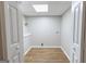 Bright laundry room with wood grain flooring and white walls, offering a clean and functional space at 203 Greensprings Dr, Palmetto, GA 30268