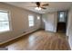Spacious living room featuring hardwood floors, a modern ceiling fan, and stairs to the upper level at 203 Greensprings Dr, Palmetto, GA 30268