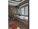 Primary bathroom featuring a soaking tub, glass enclosed shower, and windows at 711 Lily Glen Ln, Stockbridge, GA 30281