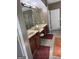 Bathroom featuring double vanity sinks with vanity lighting, a shower, and a door at 711 Lily Glen Ln, Stockbridge, GA 30281