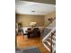 View of dining area featuring a modern light fixture and adjacent staircase leading to another level at 711 Lily Glen Ln, Stockbridge, GA 30281
