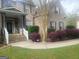 Charming brick home featuring a covered porch, landscaped garden, and an ADT security system sign at 711 Lily Glen Ln, Stockbridge, GA 30281