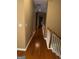 Upstairs hallway featuring hardwood floors and neutral paint, leading to the bedrooms at 711 Lily Glen Ln, Stockbridge, GA 30281