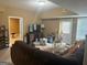 Finished living room offers a cozy seating area with natural light at 711 Lily Glen Ln, Stockbridge, GA 30281