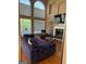Comfortable living room with a fireplace, large windows, and stylish decor with natural light at 711 Lily Glen Ln, Stockbridge, GA 30281