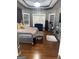 The main bedroom features tray ceilings, wood floors, and large windows at 711 Lily Glen Ln, Stockbridge, GA 30281