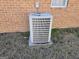Exterior AC unit sits outside a brick house on a concrete pad at 634 S Jeff Davis Dr, Fayetteville, GA 30215