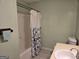 Bathroom featuring a tub with shower, a towel rack, and a single sink vanity providing a practical space at 634 S Jeff Davis Dr, Fayetteville, GA 30215