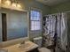 Well-lit bathroom featuring a vanity, toilet, and a shower with a stylish Eiffel Tower shower curtain at 634 S Jeff Davis Dr, Fayetteville, GA 30215
