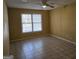 A yellow bedroom has tiled floors and one window, making it sunny and bright at 634 S Jeff Davis Dr, Fayetteville, GA 30215