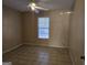 A bedroom includes tiled floors and a window, making it sunny and bright at 634 S Jeff Davis Dr, Fayetteville, GA 30215