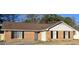 Charming one story brick home featuring black shutters, a well-maintained roof, and an inviting entrance at 634 S Jeff Davis Dr, Fayetteville, GA 30215
