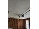 Unfinished garage with exposed studs, a window, and ceiling fan with garage door opener at 634 S Jeff Davis Dr, Fayetteville, GA 30215
