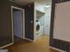 Functional laundry area with washer and dryer, neutral walls, hardwood floors and a storage closet at 634 S Jeff Davis Dr, Fayetteville, GA 30215