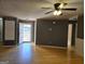 Spacious living room with hardwood floors, neutral gray walls, and a contemporary ceiling fan at 634 S Jeff Davis Dr, Fayetteville, GA 30215
