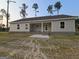 Rear view of a single-story home with an inviting porch and large backyard at 22638 Salem Church Rd, Metter, GA 30349