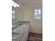 Bathroom showcasing granite countertops, white cabinets, and natural light at 22638 Salem Church Rd, Metter, GA 30349