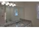 Bathroom featuring granite countertops, white cabinets, and a large mirror at 22638 Salem Church Rd, Metter, GA 30349