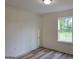 Neutral bedroom featuring wood-look floors, white trim, and natural light at 22638 Salem Church Rd, Metter, GA 30349