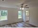 This bright bedroom offers vinyl flooring, a ceiling fan, and an attached bathroom at 22638 Salem Church Rd, Metter, GA 30349