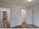 Bright bedroom featuring wood-look floors, a walk-in closet, and white trim at 22638 Salem Church Rd, Metter, GA 30349