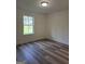 Cozy bedroom with new vinyl flooring, natural light, and crown molding at 22638 Salem Church Rd, Metter, GA 30349
