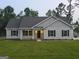 Attractive single-story home with black shutters and manicured front lawn with an inviting entryway at 22638 Salem Church Rd, Metter, GA 30349