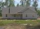 Close-up of new construction home with light-colored siding and a covered front porch at 22638 Salem Church Rd, Metter, GA 30349
