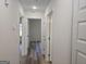 Hallway showcasing new vinyl flooring and access to multiple rooms in the home at 22638 Salem Church Rd, Metter, GA 30349