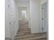 Hallway featuring multiple doorways and vinyl flooring at 22638 Salem Church Rd, Metter, GA 30349
