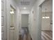 Hallway with wood-look floors leading to a bathroom and kitchen at 22638 Salem Church Rd, Metter, GA 30349