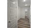 Hallway with wood-look floors leading to the laundry room at 22638 Salem Church Rd, Metter, GA 30349