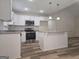 Modern kitchen featuring white cabinets, stainless appliances, granite countertops, and an island at 22638 Salem Church Rd, Metter, GA 30349