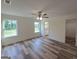 Spacious main bedroom featuring wood-look floors, a ceiling fan, and a walk-in closet at 22638 Salem Church Rd, Metter, GA 30349