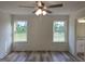 Main bedroom featuring wood-look floors, a ceiling fan, and natural light at 22638 Salem Church Rd, Metter, GA 30349