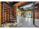 View of basement with brick fireplace, exposed utilities and spiral staircase at 509 Eskew Rd, Mcdonough, GA 30252