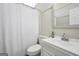 This bathroom features a toilet, sink and shower with white tile at 509 Eskew Rd, Mcdonough, GA 30252