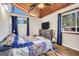 Cozy bedroom features wood ceiling, hardwood floors, comfy bed, and entertainment center at 509 Eskew Rd, Mcdonough, GA 30252