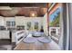 Cozy dining area with a wooden table, white chairs, and a view to the backyard through double doors at 509 Eskew Rd, Mcdonough, GA 30252